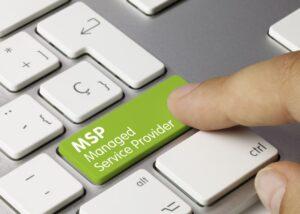 MSP Managed Service Provider Written on Green Key of Metallic Keyboard. Finger pressing key.